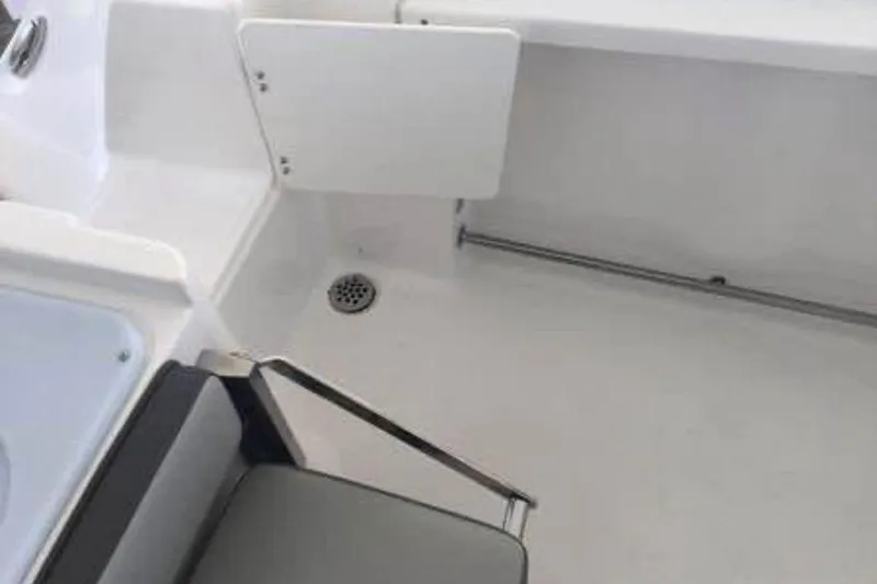 Slide: The Image of Interior view of 2022 Aquasport 2500 Center Console boat, featuring seating and drainage. - 14