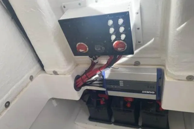 Slide: The Image of Electrical panel and battery setup in 2022 Aquasport 2500 Center Console boat. - 16