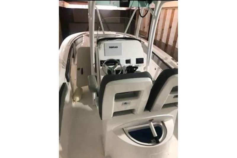 Slide: The Image of 2022 Aquasport 2500 Center Console boat interior with steering console and seating. - 5