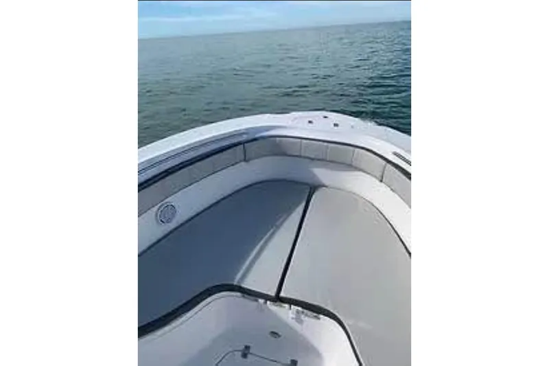 Slide: The Image of 2022 Aquasport 2500 Center Console boat on calm ocean waters. - 7