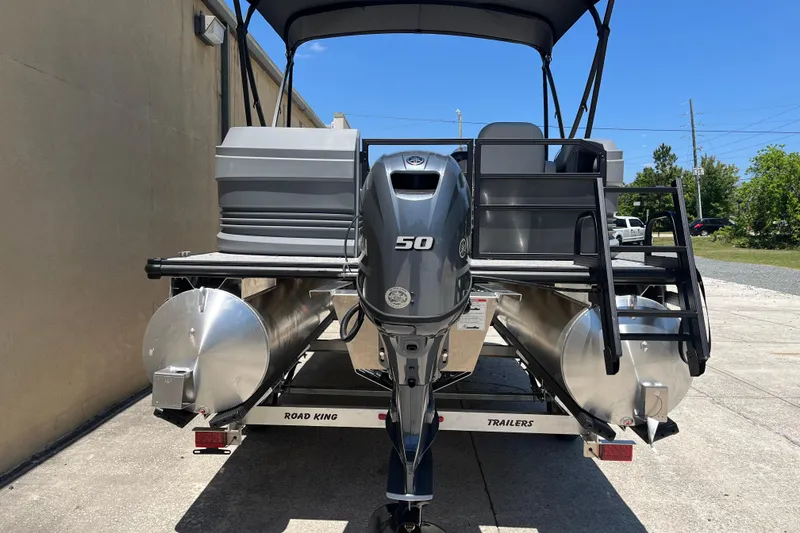 Slide: The Image of 2026 Starcraft GX 18 R pontoon boat with 50 HP engine on trailer. - 11
