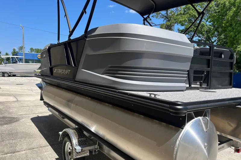 Slide: The Image of 2026 Starcraft GX 18 R pontoon boat on trailer, featuring sleek design and modern amenities. - 13