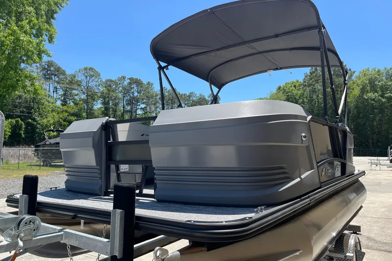 Slide: The Image of 2026 Starcraft GX 18 R pontoon boat on trailer, sunny outdoor setting. - 16