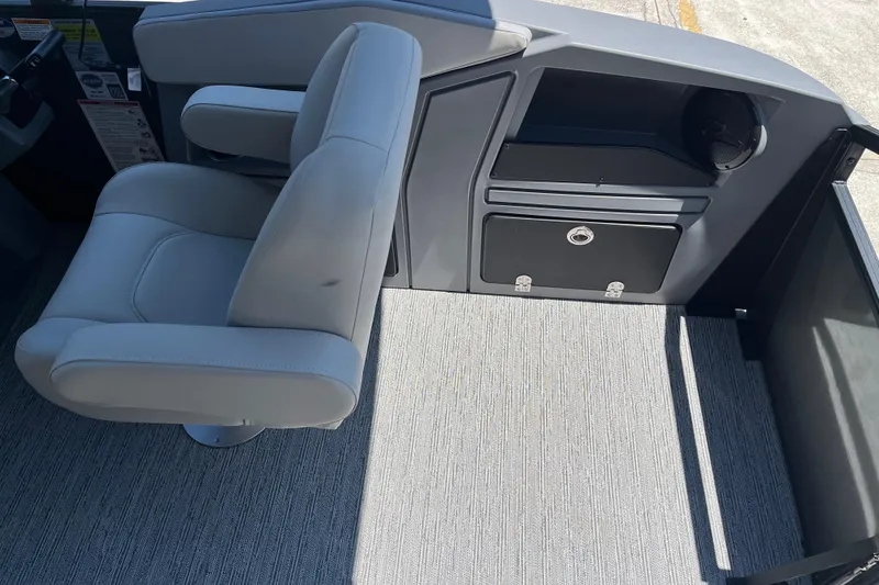 Slide: The Image of Captain's chair and console of 2026 Starcraft GX 18 R boat, featuring sleek design and storage. - 26
