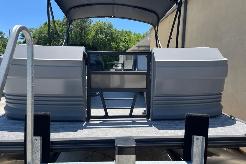 Slide: The Image of 2026 Starcraft GX 18 R pontoon boat with canopy, docked outdoors. - 3