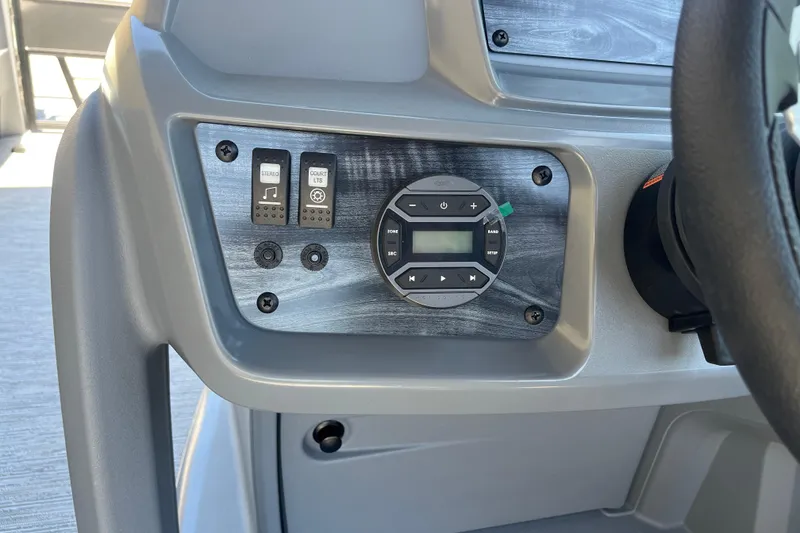 Slide: The Image of Control panel of 2026 Starcraft GX 18 R boat with stereo and light switches. - 30