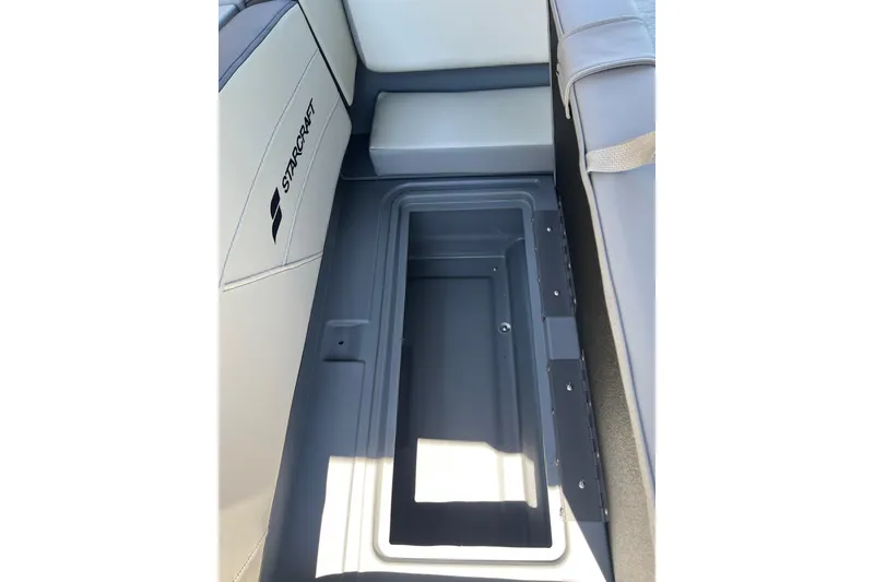 Slide: The Image of Starcraft GX 18 R 2026 boat interior storage compartment with cushioned seating. - 36