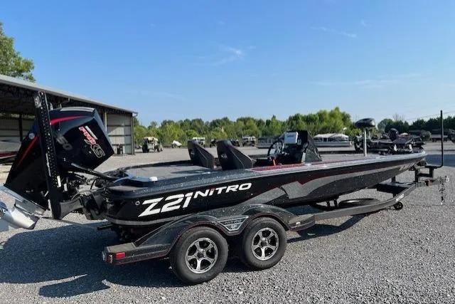 Slide: The Image of 2024 Nitro Z21 XL boat on trailer in outdoor setting. - 10
