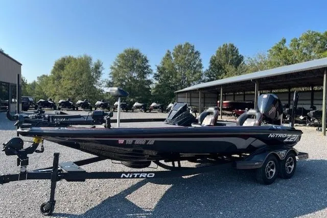 Slide: The Image of 2024 Nitro Z21 XL boat on trailer in outdoor storage area. - 8