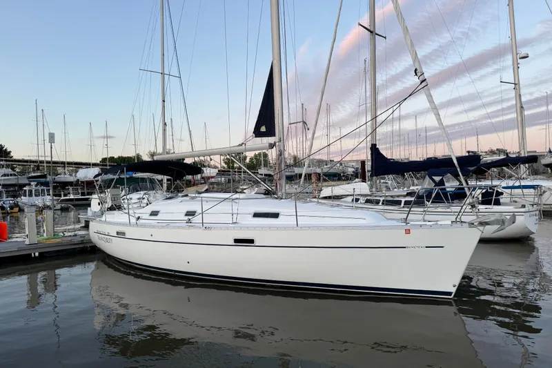 The Image of 2005 Beneteau 331 sailboat docked at marina, reflecting on calm water. - 0