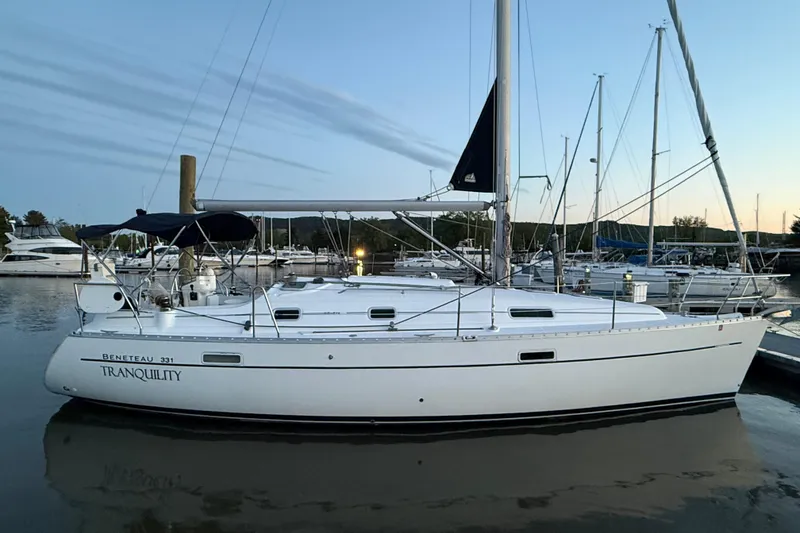 Slide: The Image of 2005 Beneteau 331 sailboat docked at marina during sunset. - 2