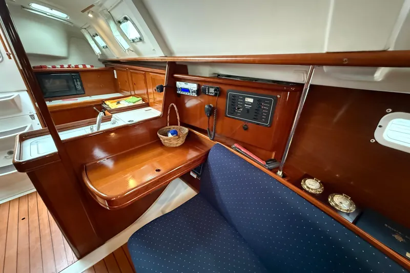 Slide: The Image of Interior of 2005 Beneteau 331 sailboat with wooden cabinetry and navigation equipment. - 5
