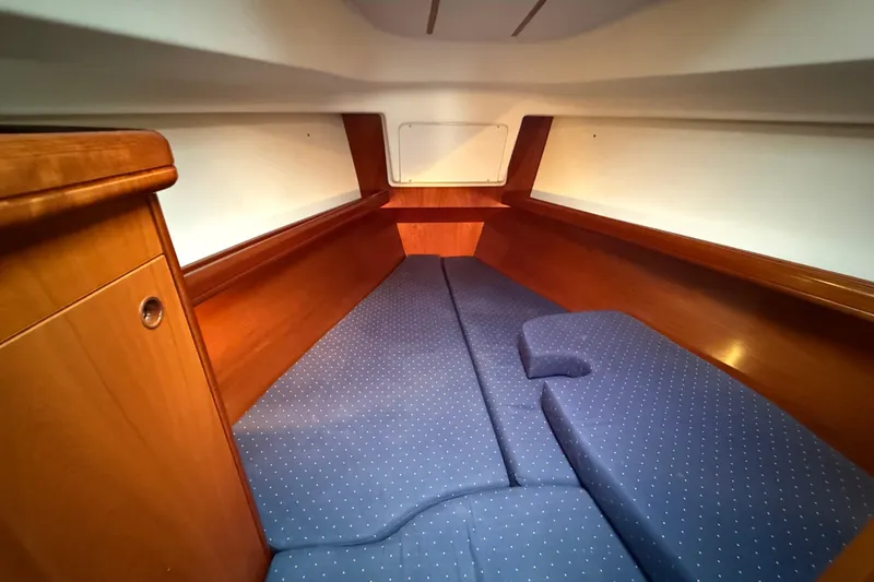 Slide: The Image of Cozy cabin interior of 2005 Beneteau 331 sailboat with blue cushioned seating. - 7