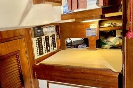 Slide: The Image of 1983 Nonsuch Cat Ketch interior with navigation station and control panels. - 18