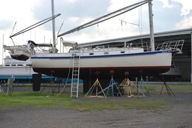 Slide: The Image of 1983 Nonsuch Cat Ketch sailboat on stands in a boatyard. - 23