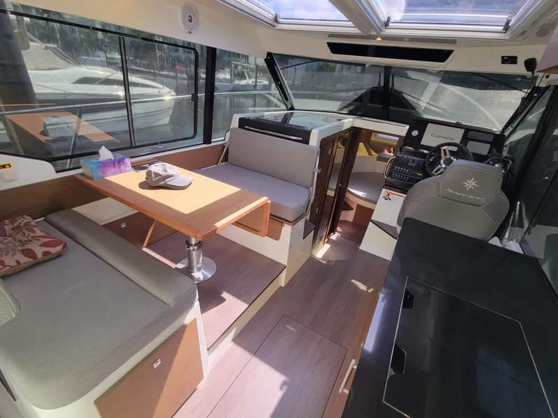Slide: The Image of Interior of 2020 Jeanneau NC1095 boat with seating, table, and helm station. - 20