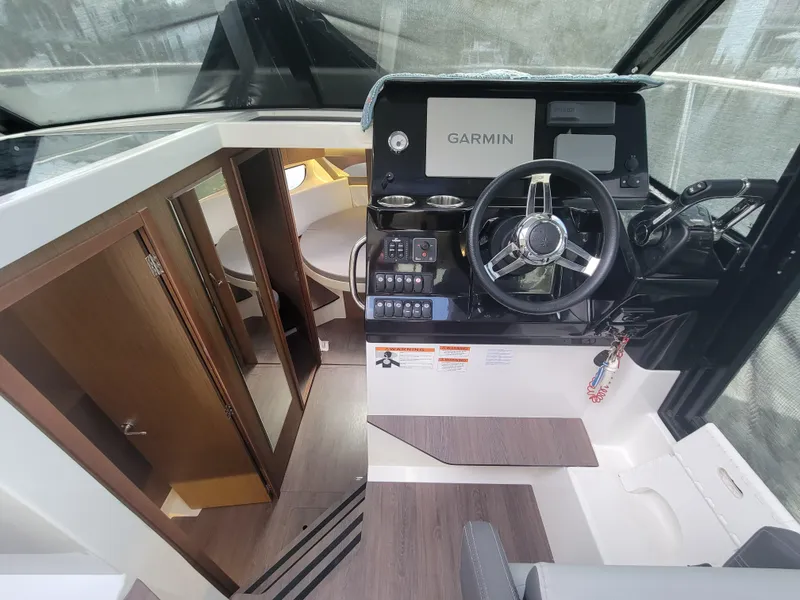 Slide: The Image of Interior view of 2020 Jeanneau NC1095 boat with helm and cabin area. - 27
