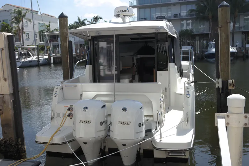 Slide: The Image of 2020 Jeanneau NC1095 boat docked with twin 300 engines, rear view. - 3
