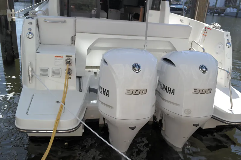 Slide: The Image of 2020 Jeanneau NC1095 boat with dual Yamaha 300 engines docked at marina. - 4