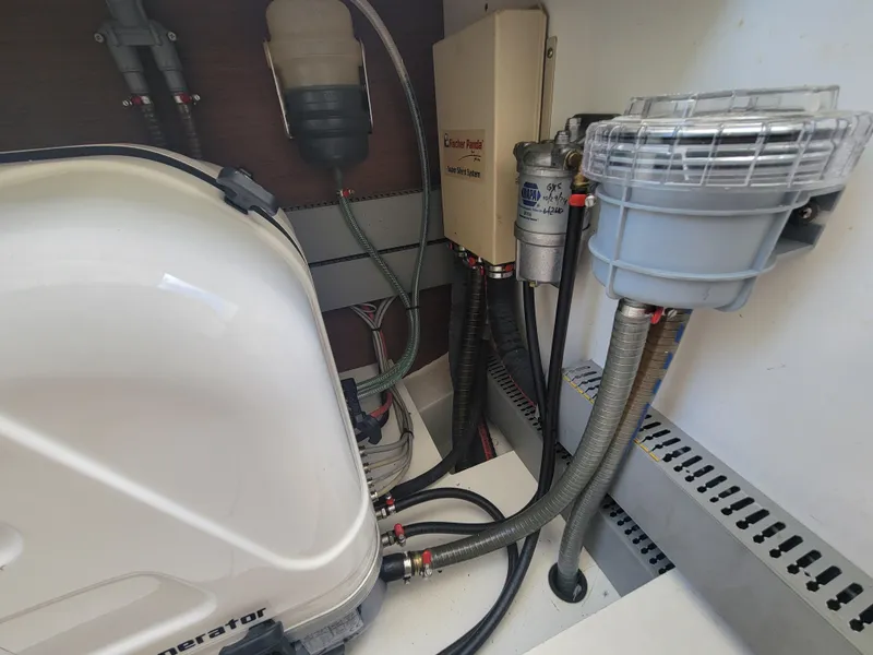 Slide: The Image of Engine compartment of a 2020 Jeanneau NC1095 boat, showcasing various mechanical components and hoses. - 42
