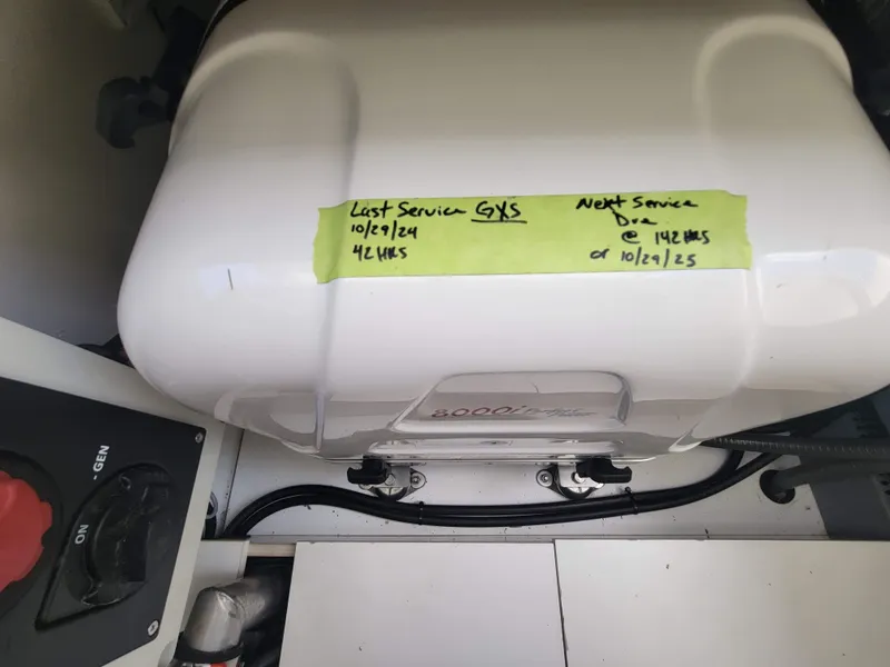 Slide: The Image of Engine compartment of 2020 Jeanneau NC1095 with service schedule note. - 43