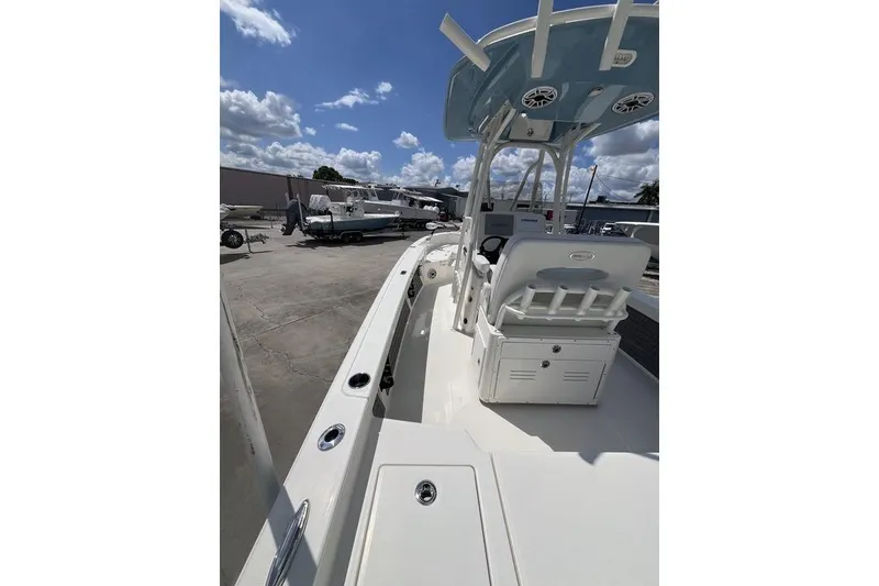 Slide: The Image of 2023 Pathfinder 2400 TRS boat, sleek design, docked under a clear blue sky. - 14