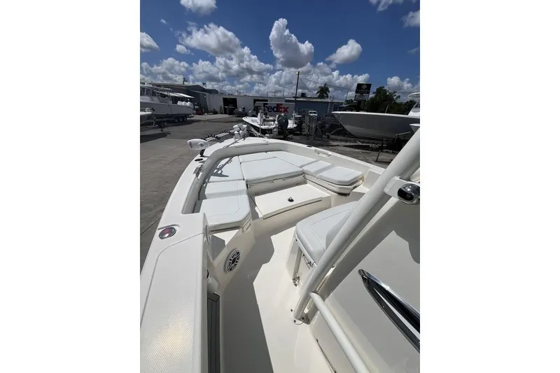 Slide: The Image of 2023 Pathfinder 2400 TRS boat with spacious seating, parked outdoors under a cloudy sky. - 15