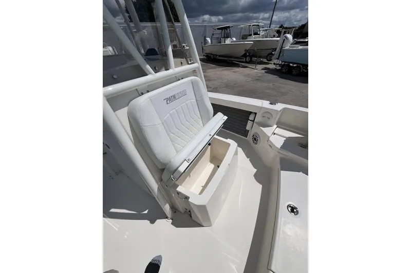 Slide: The Image of 2023 Pathfinder 2400 TRS boat seat with storage compartment, outdoor setting. - 18