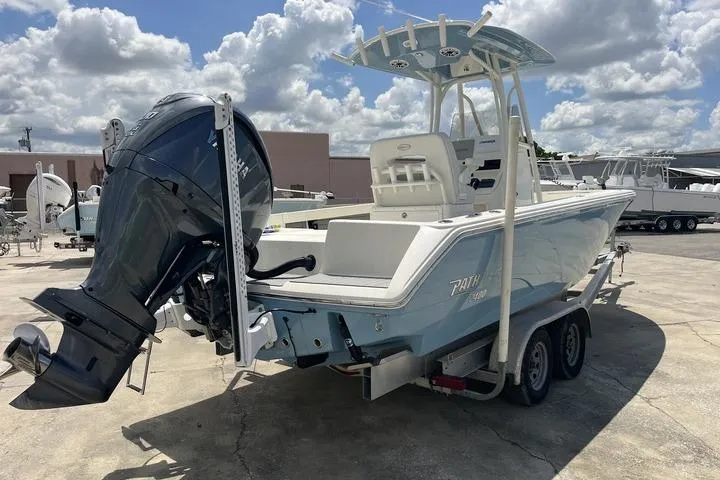 Slide: The Image of 2023 Pathfinder 2400 TRS boat on trailer, featuring powerful outboard motor. - 2