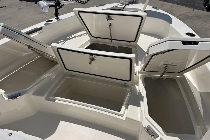 Slide: The Image of 2023 Pathfinder 2400 TRS boat storage compartments open, showcasing spacious interior design. - 20