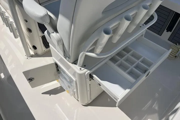Slide: The Image of 2023 Pathfinder 2400 TRS boat interior with storage compartments and rod holders. - 22