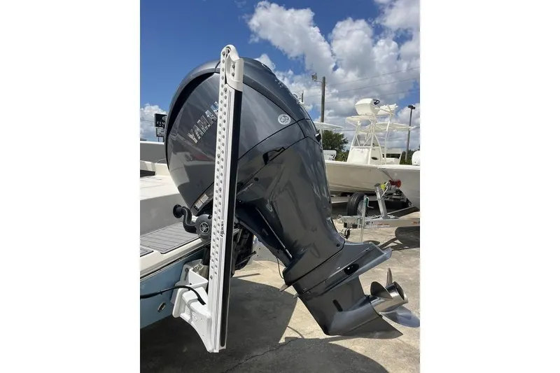 Slide: The Image of 2023 Pathfinder 2400 TRS boat with Yamaha outboard motor, parked outdoors under a cloudy sky. - 23