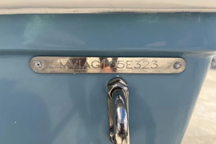 Slide: The Image of 2023 Pathfinder 2400 TRS boat hull identification number on blue surface. - 24