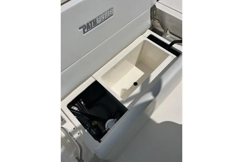 Slide: The Image of 2023 Pathfinder 2400 TRS boat storage compartment with open lid, showcasing interior space. - 5