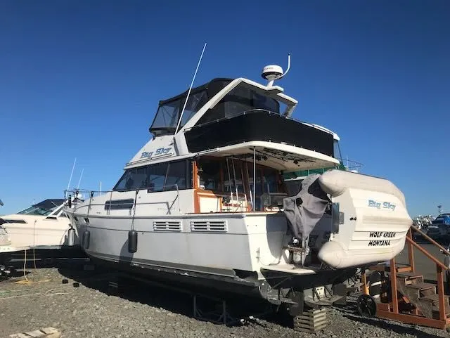 Slide: The Image of 1990 Bayliner 3888 Motoryacht on land, clear sky. - 1