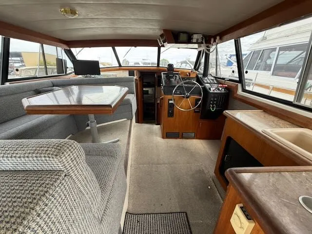 Slide: The Image of Interior of 1990 Bayliner 3888 Motoryacht with helm and seating area. - 12