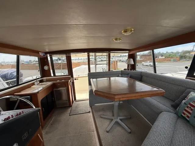 Slide: The Image of Interior of 1990 Bayliner 3888 Motoryacht with dining area. - 13
