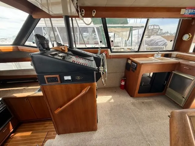 Slide: The Image of Interior of 1990 Bayliner 3888 Motoryacht with helm and kitchenette. - 17
