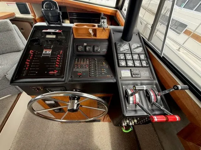 Slide: The Image of 1990 Bayliner 3888 Motoryacht helm with instruments and throttle controls. - 19