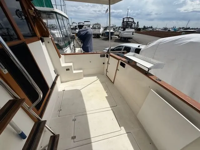 Slide: The Image of 1990 Bayliner 3888 Motoryacht, spacious aft deck at marina. - 2