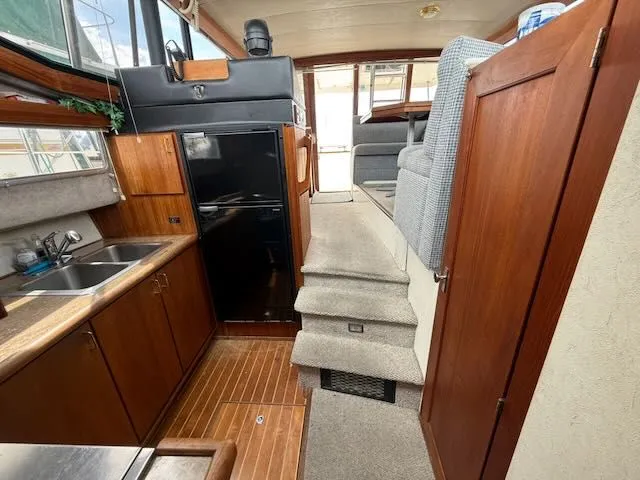 Slide: The Image of Interior of 1990 Bayliner 3888 Motoryacht with kitchen and stairs. - 23