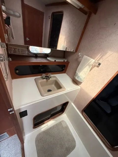 Slide: The Image of 1990 Bayliner 3888 Motoryacht interior, bathroom with sink and mirror. - 30