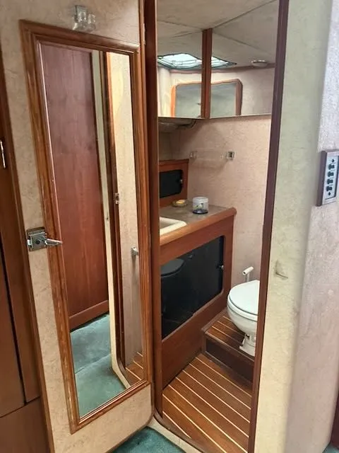 Slide: The Image of Interior of 1990 Bayliner 3888 Motoryacht featuring bathroom and mirror. - 35
