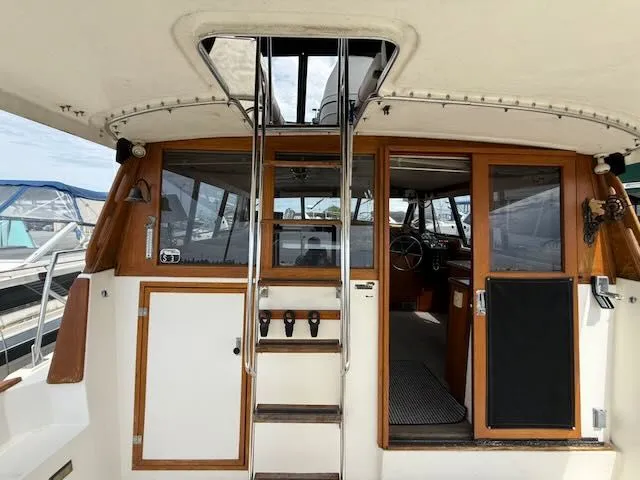 Slide: The Image of 1990 Bayliner 3888 Motoryacht interior with ladder and cockpit view. - 37