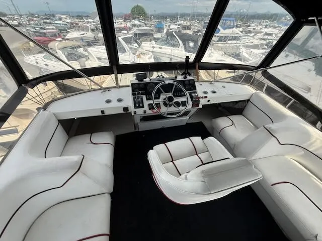 Slide: The Image of 1990 Bayliner 3888 Motoryacht interior with white seating area. - 38