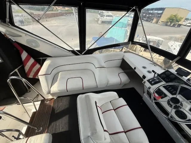 Slide: The Image of 1990 Bayliner 3888 Motoryacht interior with white seating area. - 39