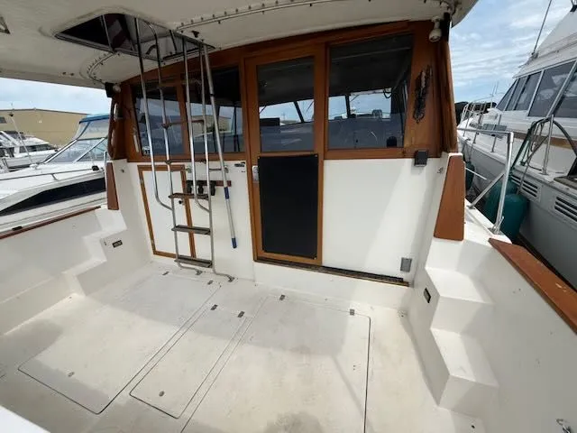 Slide: The Image of 1990 Bayliner 3888 Motoryacht with spacious cockpit and wooden accents. - 4
