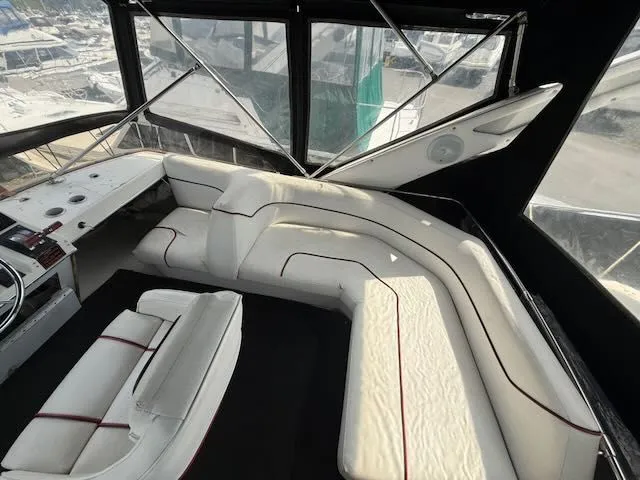 Slide: The Image of 1990 Bayliner 3888 Motoryacht interior with white leather seating. - 40