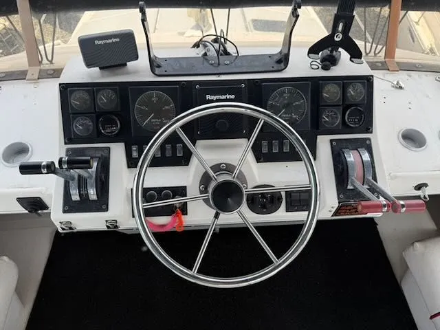 Slide: The Image of 1990 Bayliner 3888 Motoryacht helm with Raymarine equipment. - 43