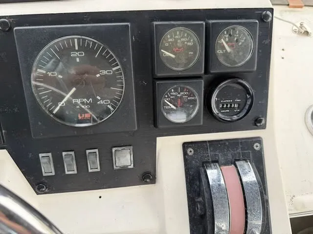 Slide: The Image of Dashboard of 1990 Bayliner 3888 Motoryacht with tachometer and switches. - 45